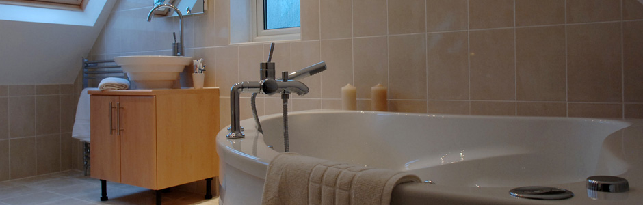 Bath and sink in loft conversion bathroom